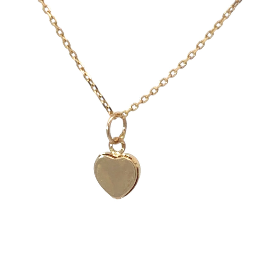 Close-up of minimalist heart-shaped gold pendant