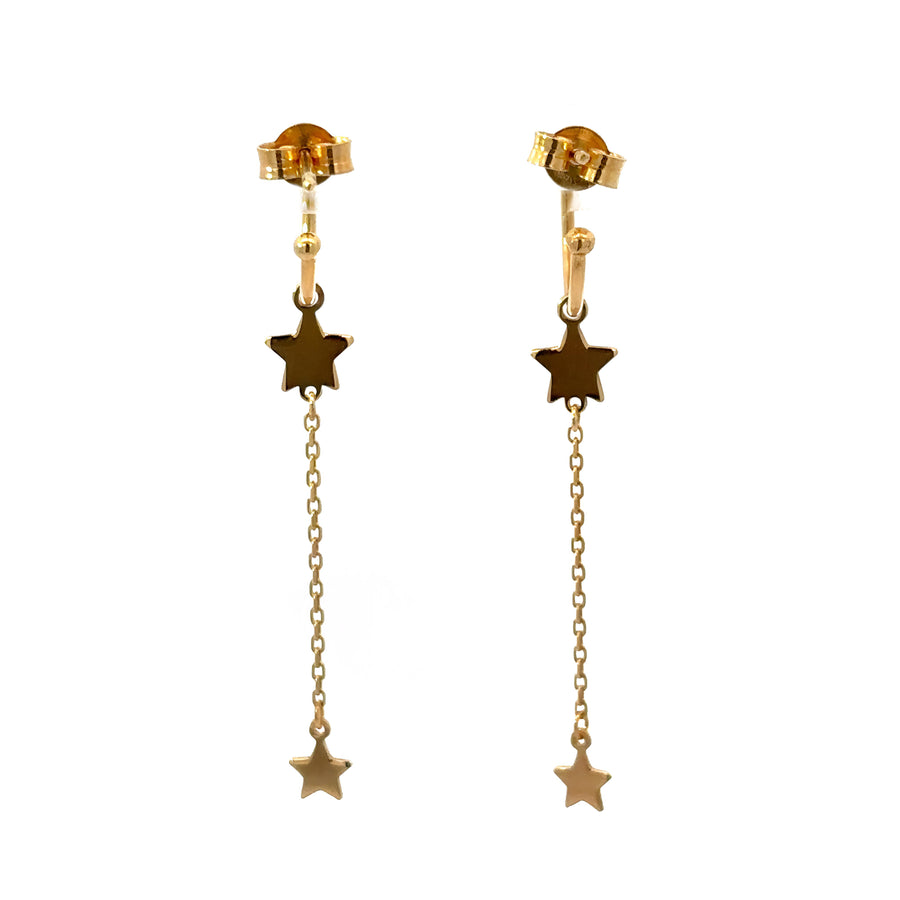 Woman wearing 14k gold hoop earrings with celestial design