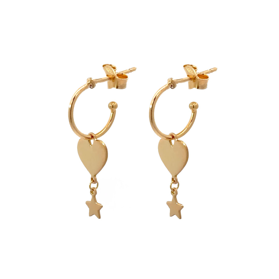 Close-up of solid heart and star hanging from gold hoops