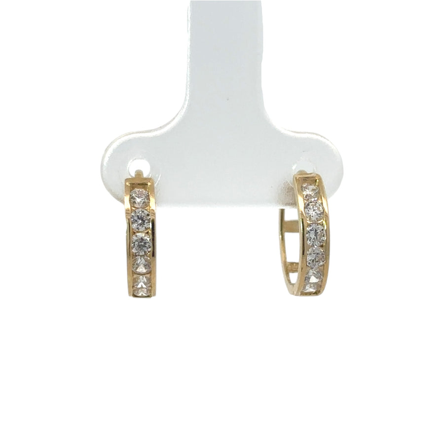 Close-up of cubic zirconia line on gold XS huggie earrings