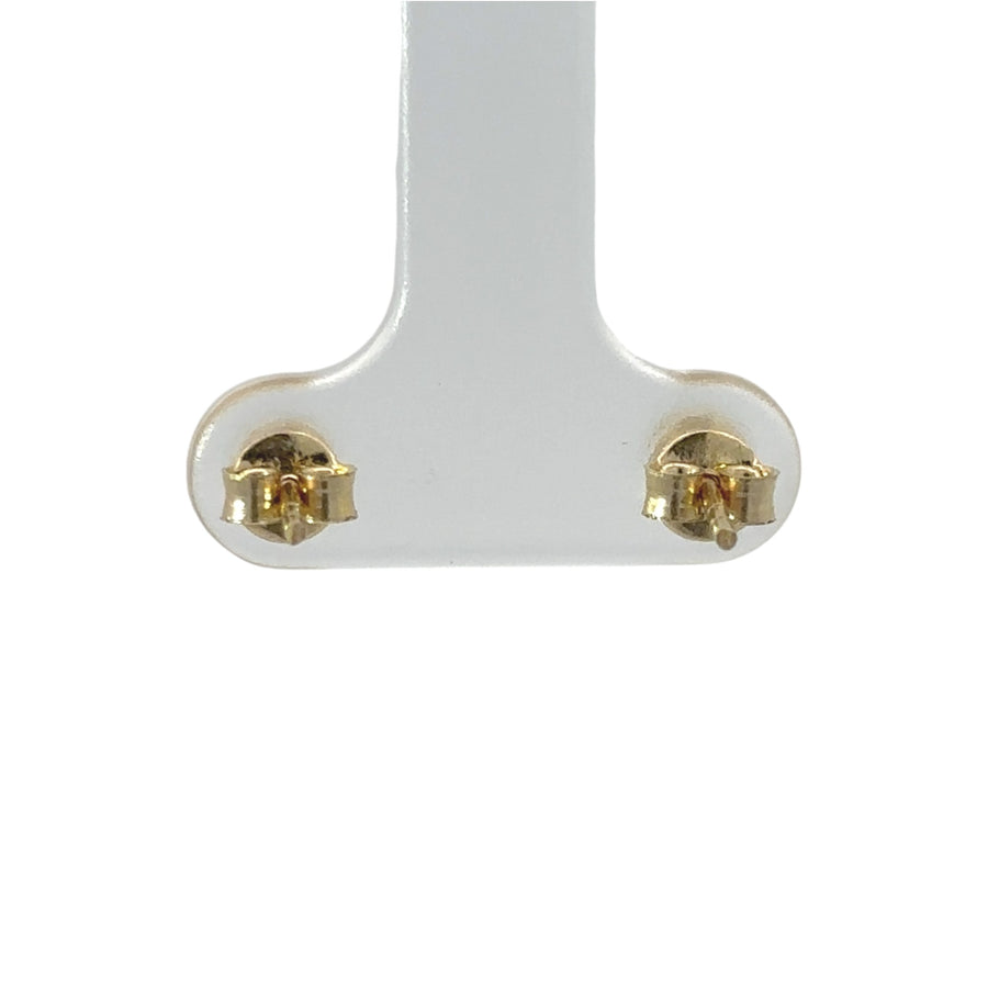 Dainty gold stud earrings styled for everyday wear