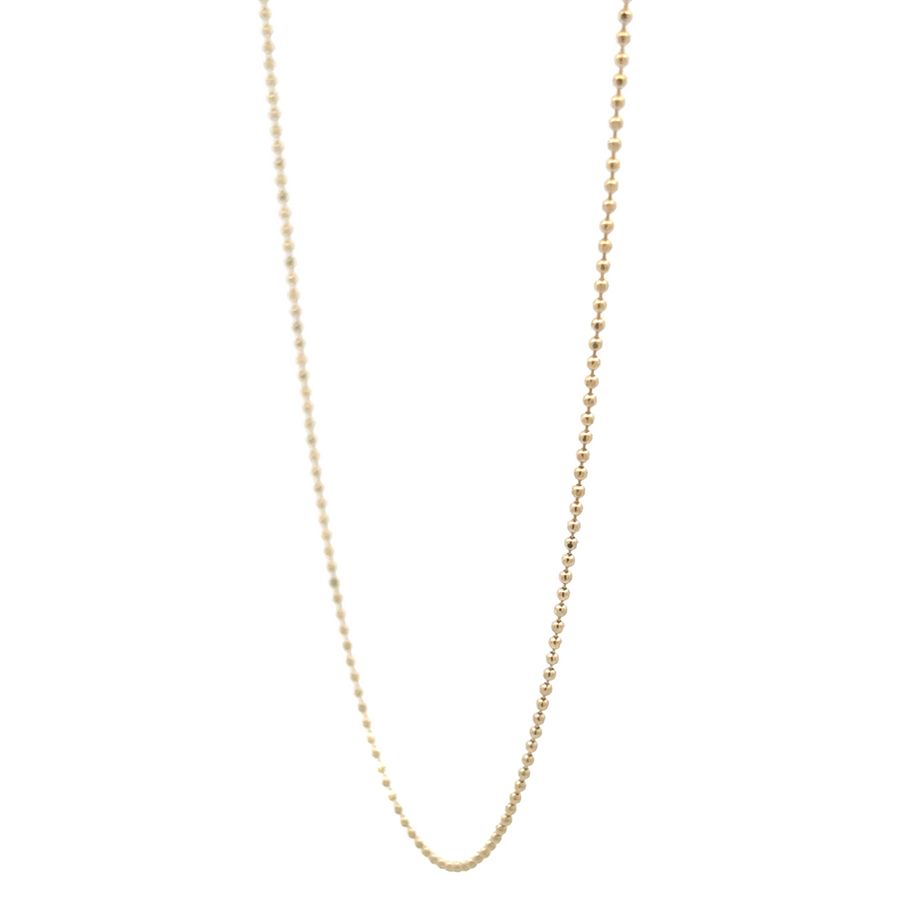 Close-up of XXS gold ball links showing fine detail