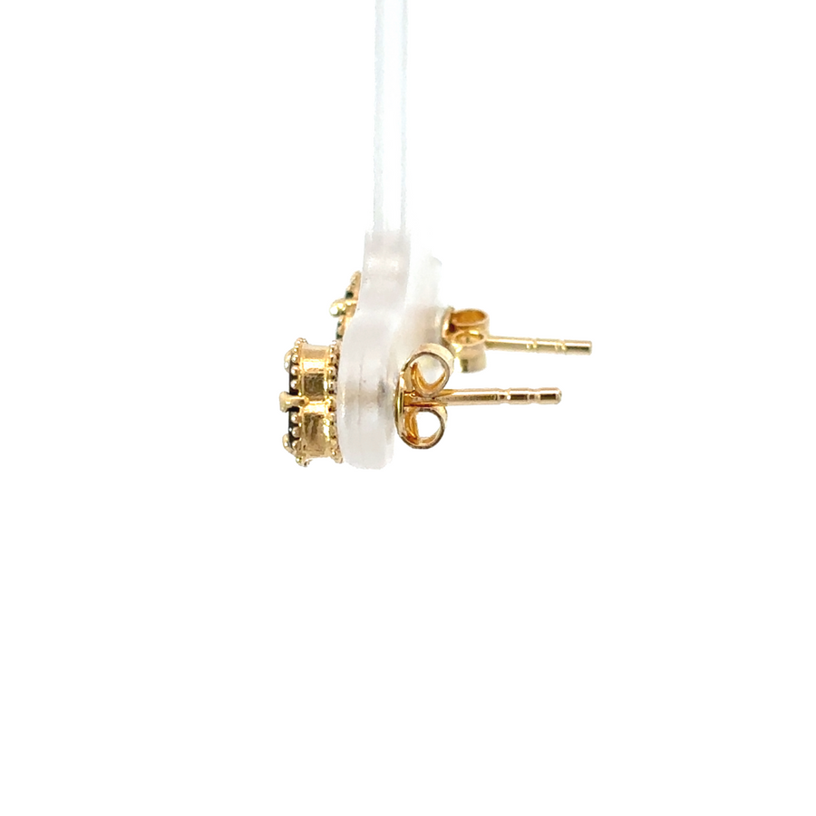 XXS gold earrings next to a ruler to showcase their size