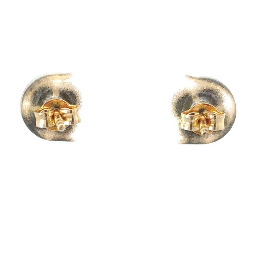 Woman wearing 14k gold XXS earrings in a second piercing