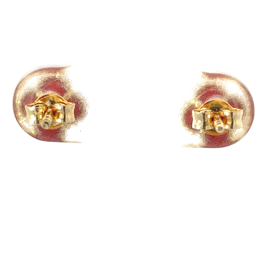 Woman wearing 14k gold XXS earrings with a red gemstone