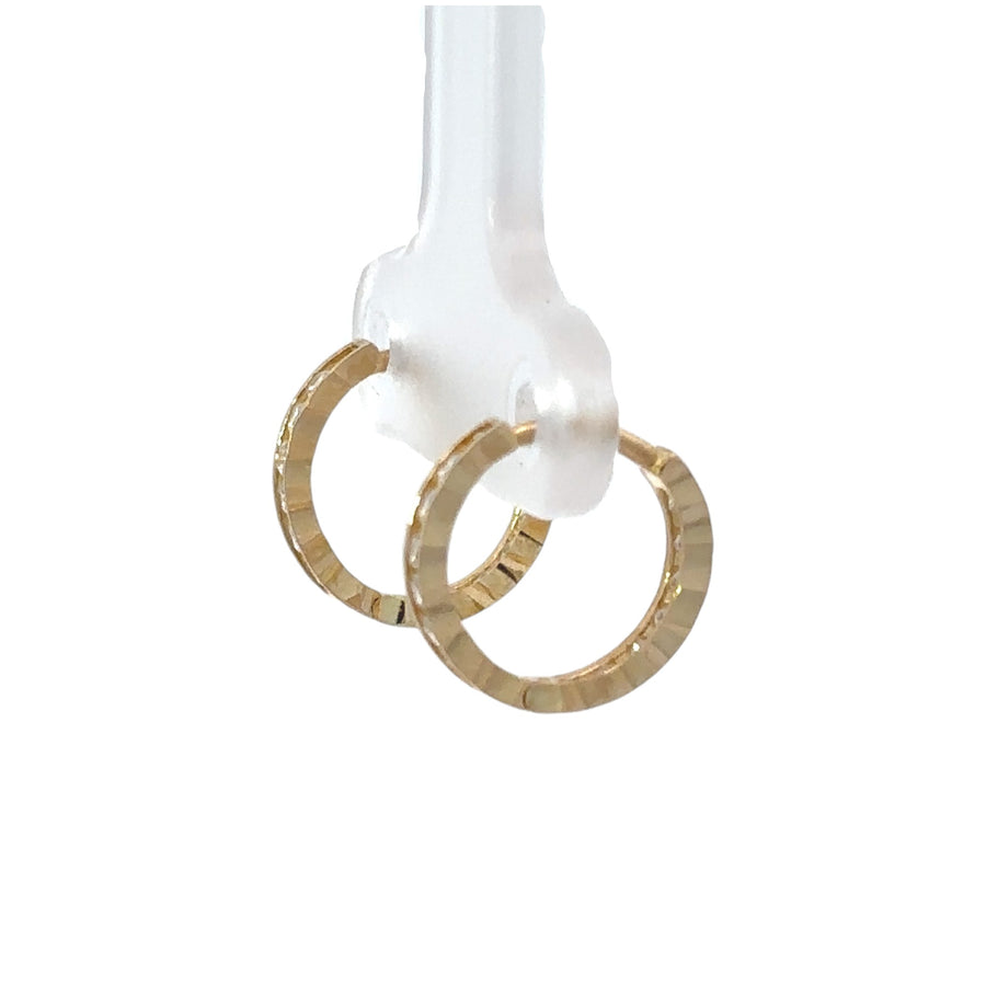 Baby with small 14k gold huggie earrings featuring CZ accents
