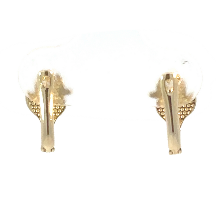 Duck earrings styled on soft yellow fabric for a charming display