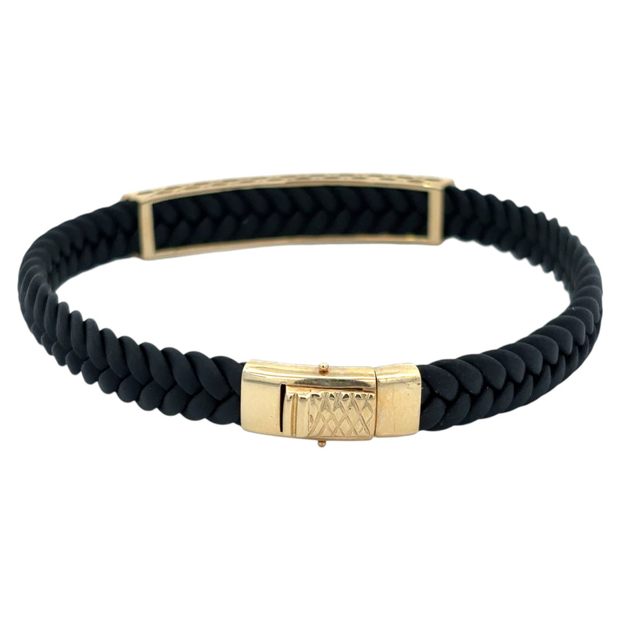 Close-up of gold accent on black leather men’s bracelet