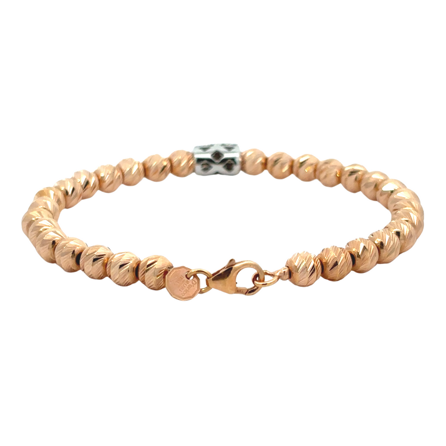 Close-up of 14k rose gold braid bracelet with diamond details