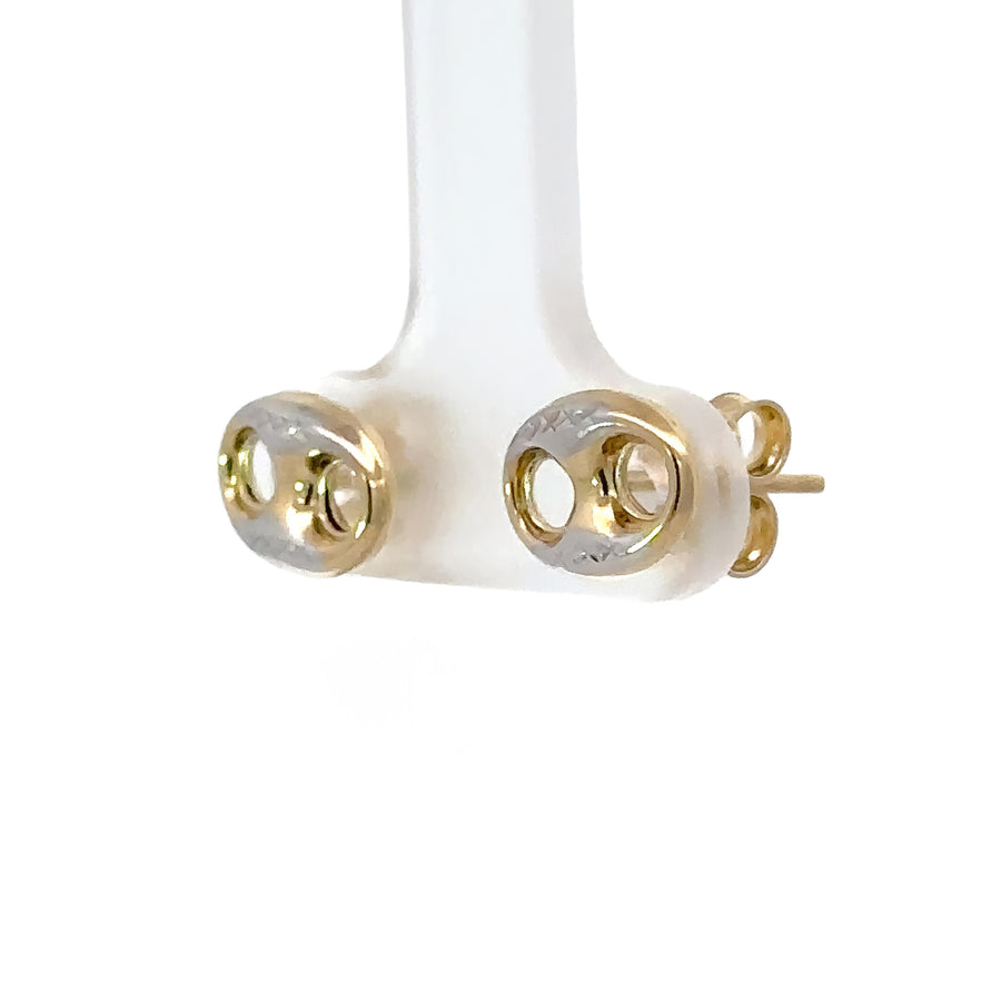 Woman wearing 14k two-tone gold earrings with formal outfit