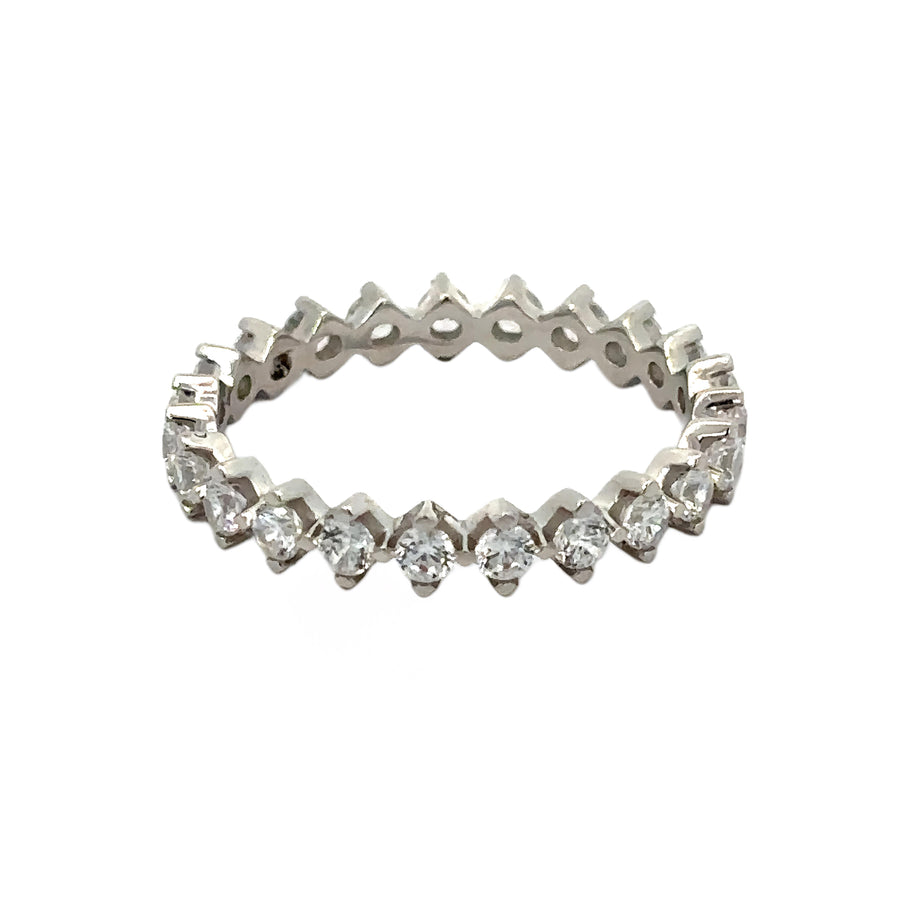 Close-up of white gold band ring featuring CZ accents