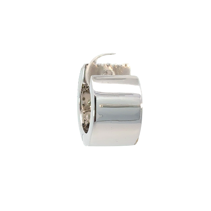 Close-up of white gold earrings featuring diamonds and gemstones