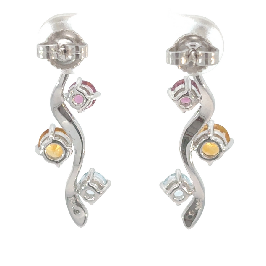 Model wearing classic white gold earrings with 3 diamonds