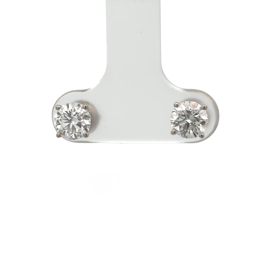 Lab diamond earrings displayed on white velvet