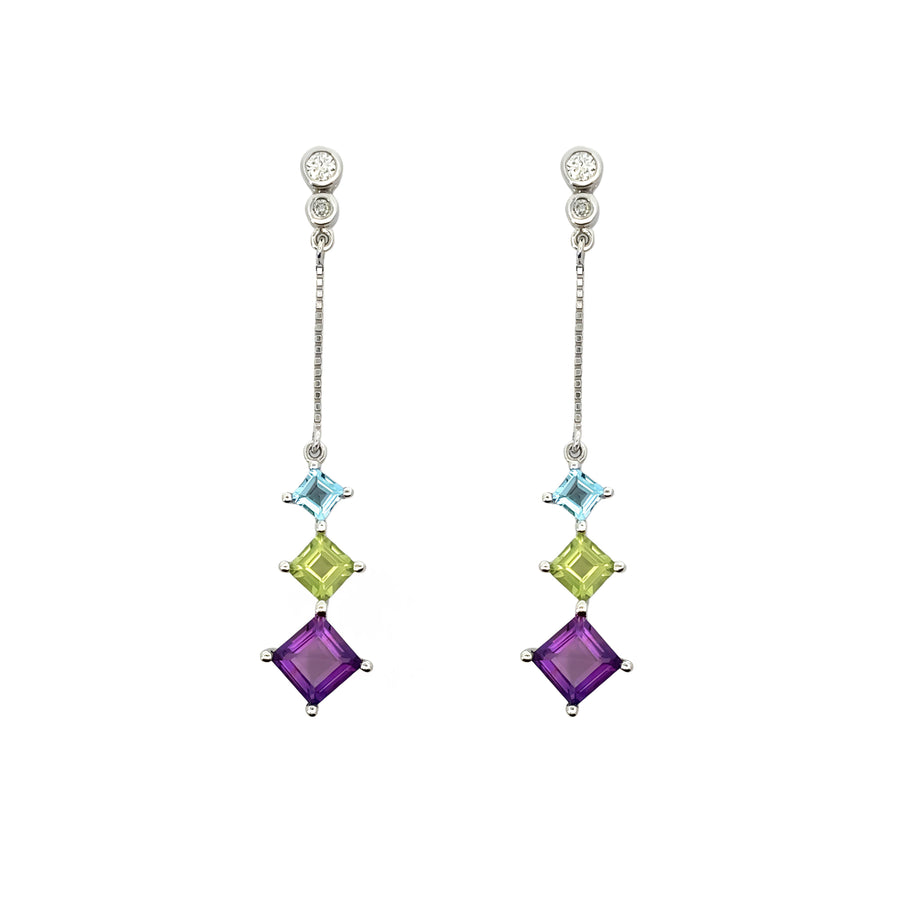 Close-up of elegant white gold earrings featuring a stone centerpiece
