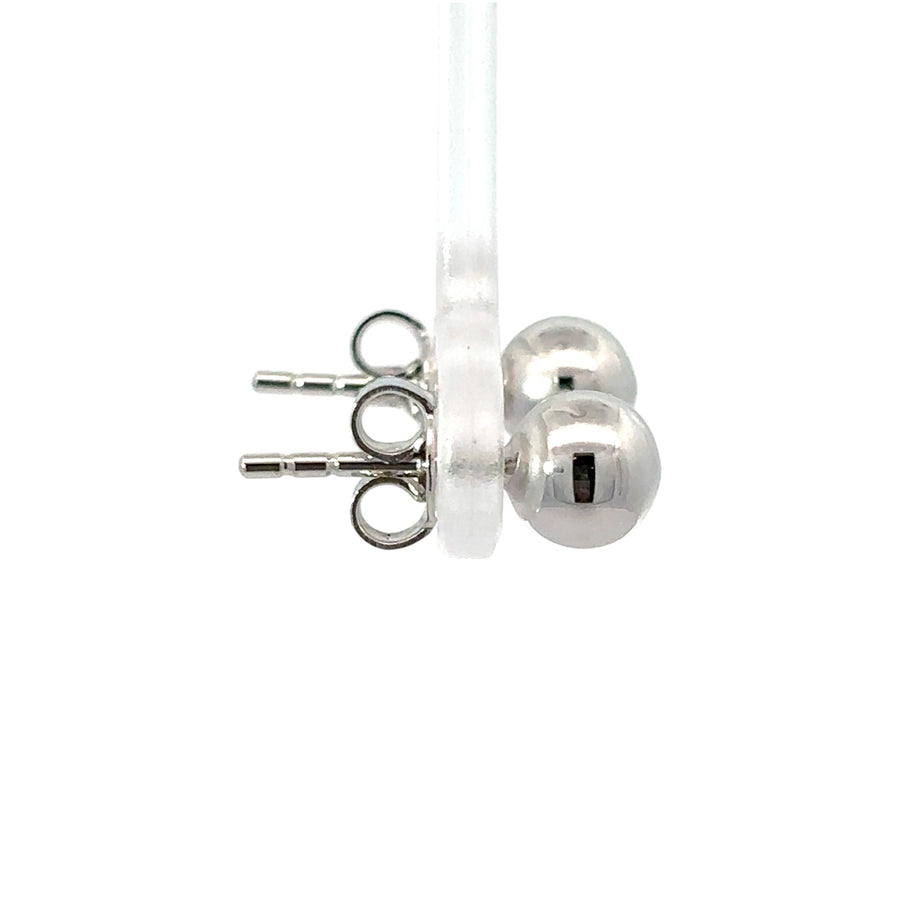 Close-up of polished white gold stud earring in medium size