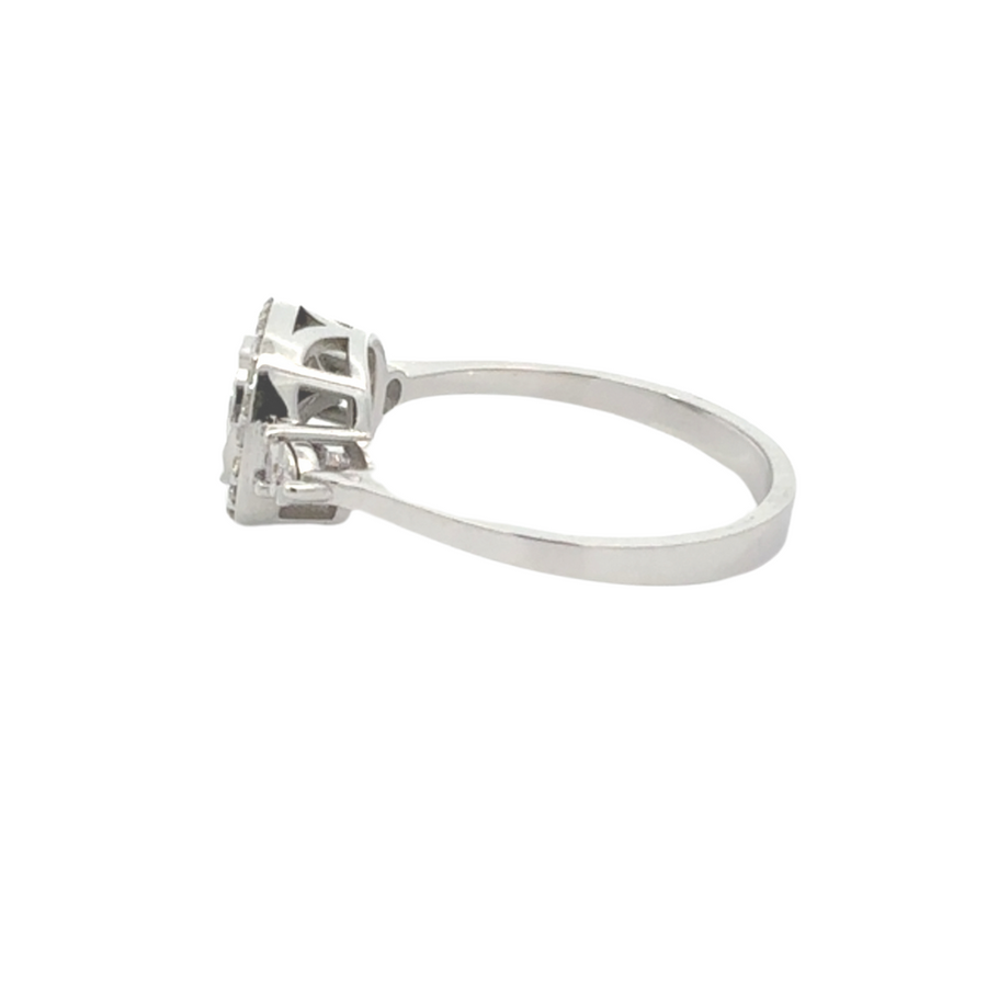 Side view of white gold diamond ring on neutral background