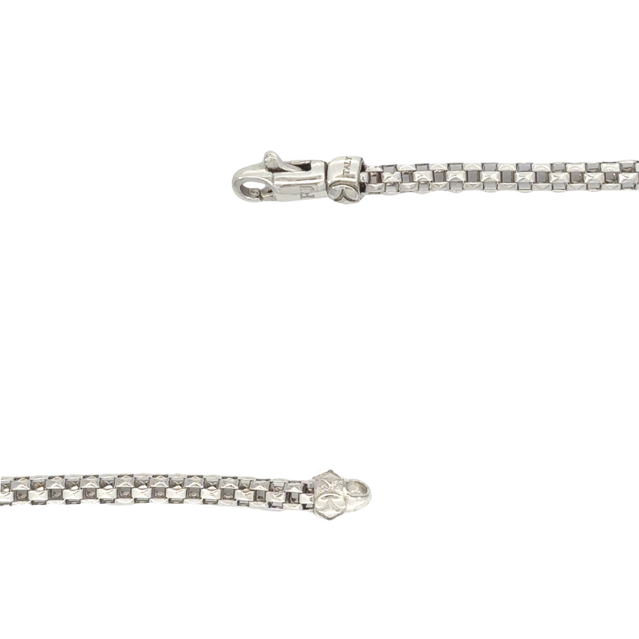 Detailed view of 14k white gold bracelet, featuring brilliant cubic zirconia at the center