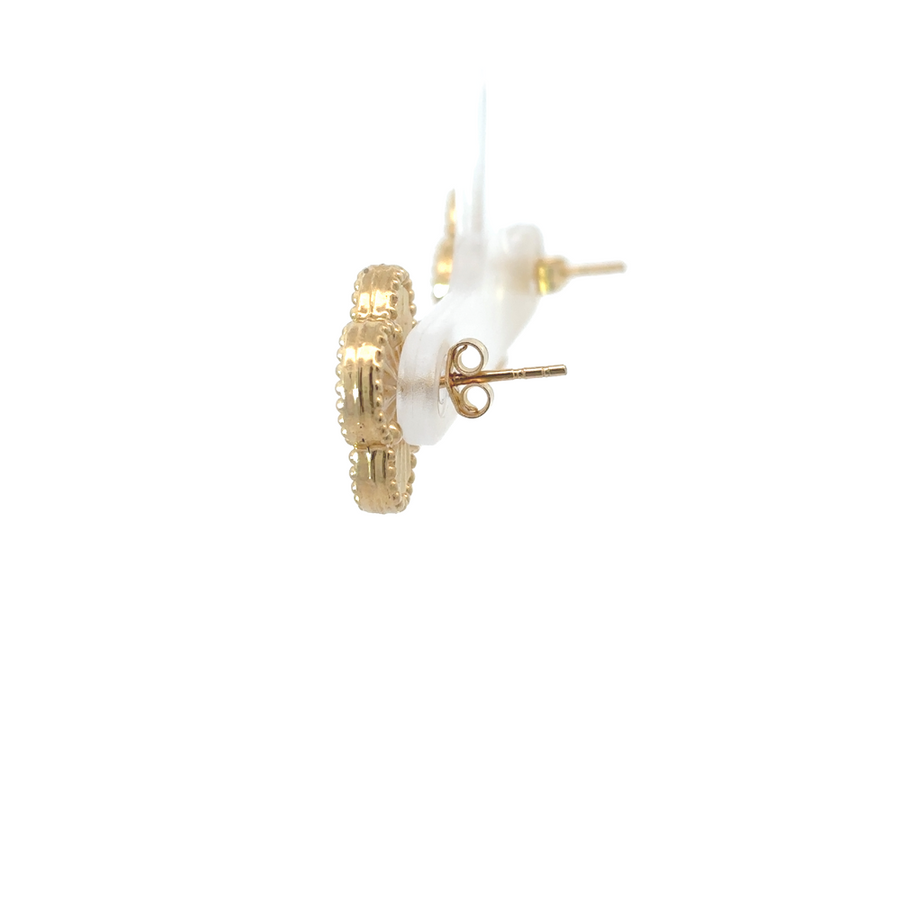 Close-up of black accent detailing on gold earrings