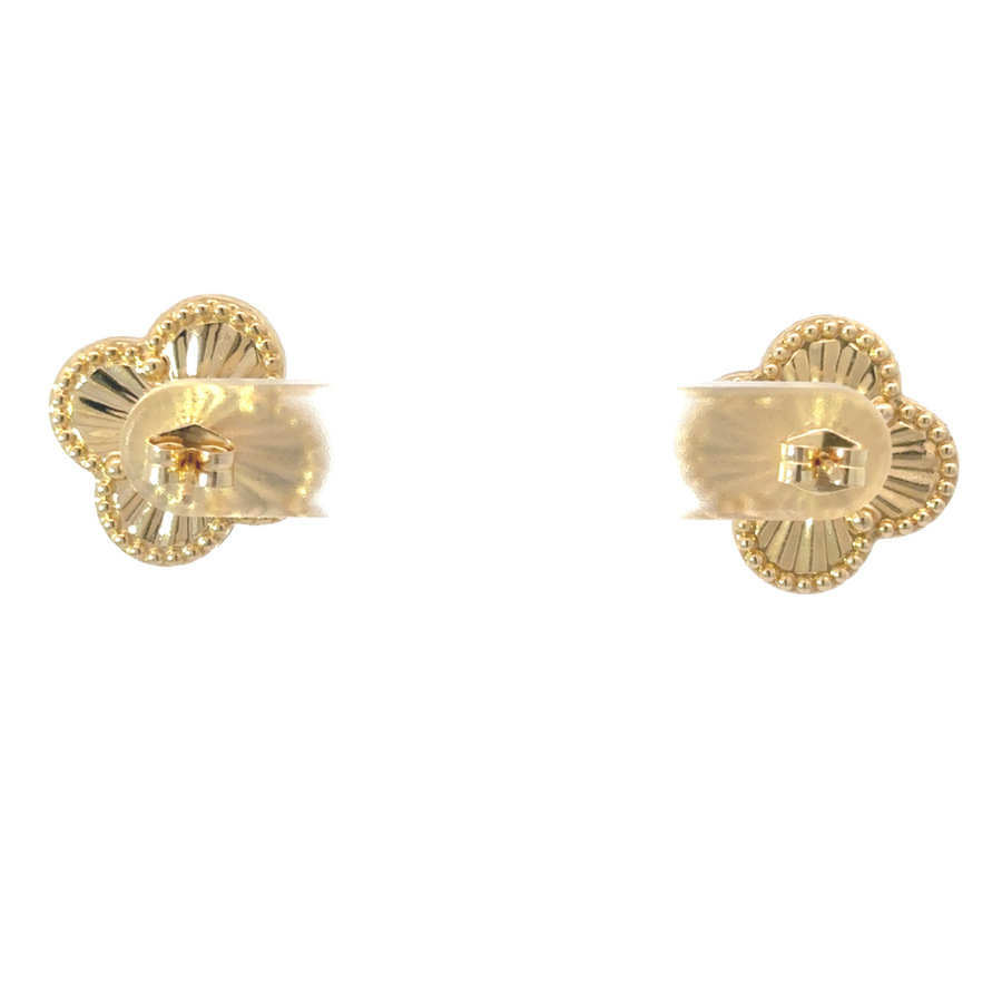 Woman wearing 14k gold earrings with a black dress