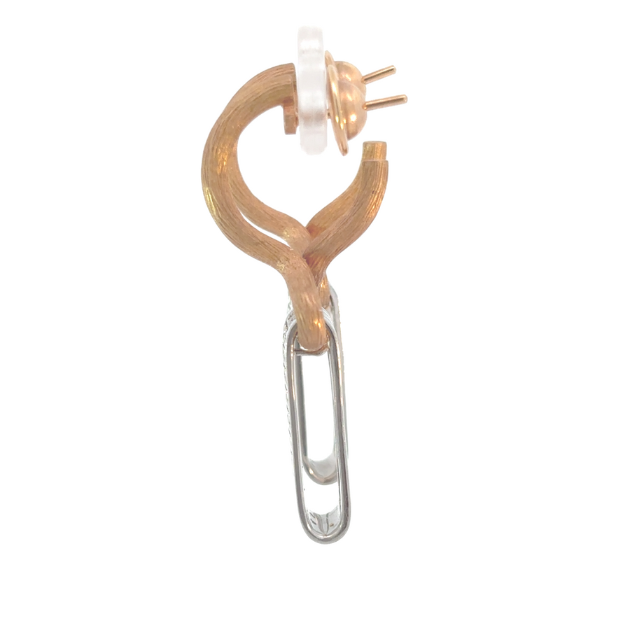 Side view of two-tone gold earrings showcasing diamond accents