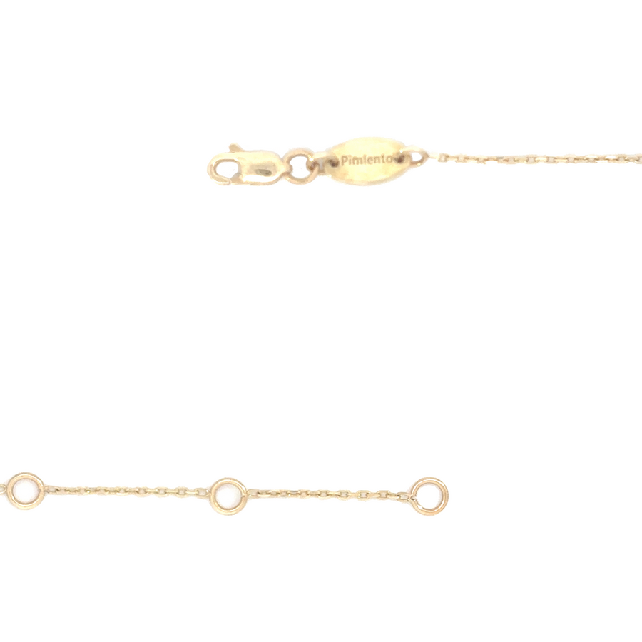 Woman wearing the 18k gold bracelet on her wrist with a minimalist outfit.