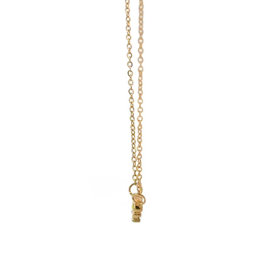 Close-up of elegant 18k gold crown pendant on adjustable necklace
