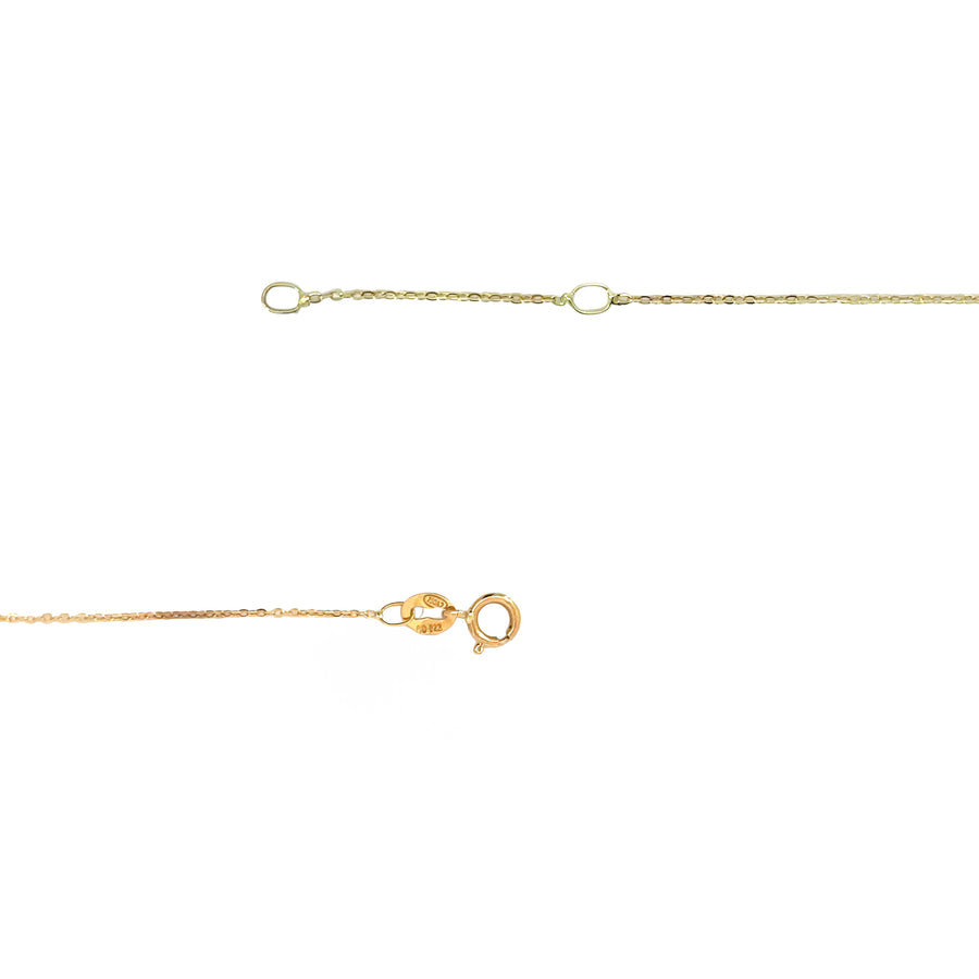 Woman wearing 18k gold crown necklace with a delicate fit