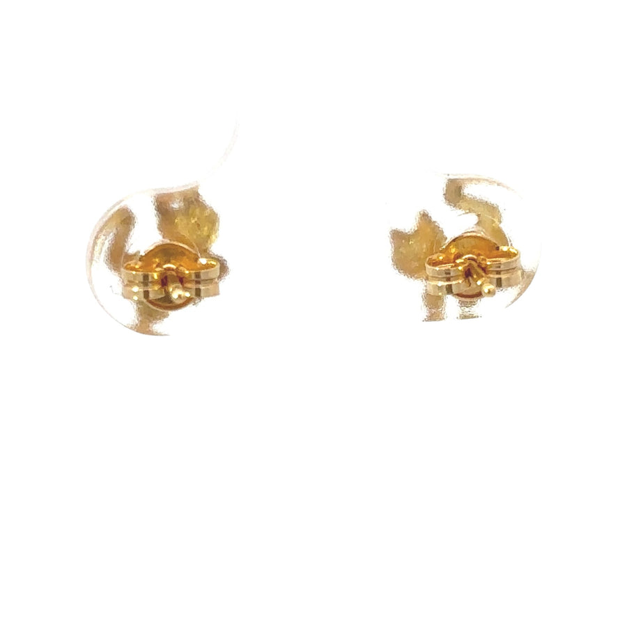 Baby girl wearing delicate 18k gold stud earrings
