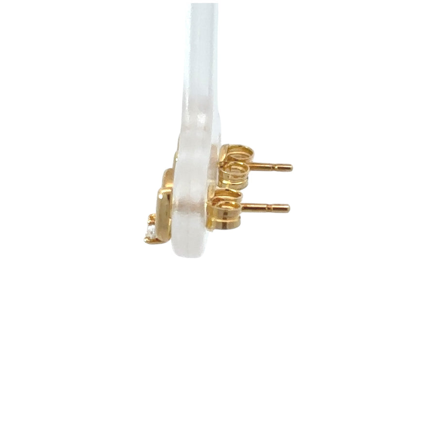 Close-up of small 18k gold earrings designed for babies