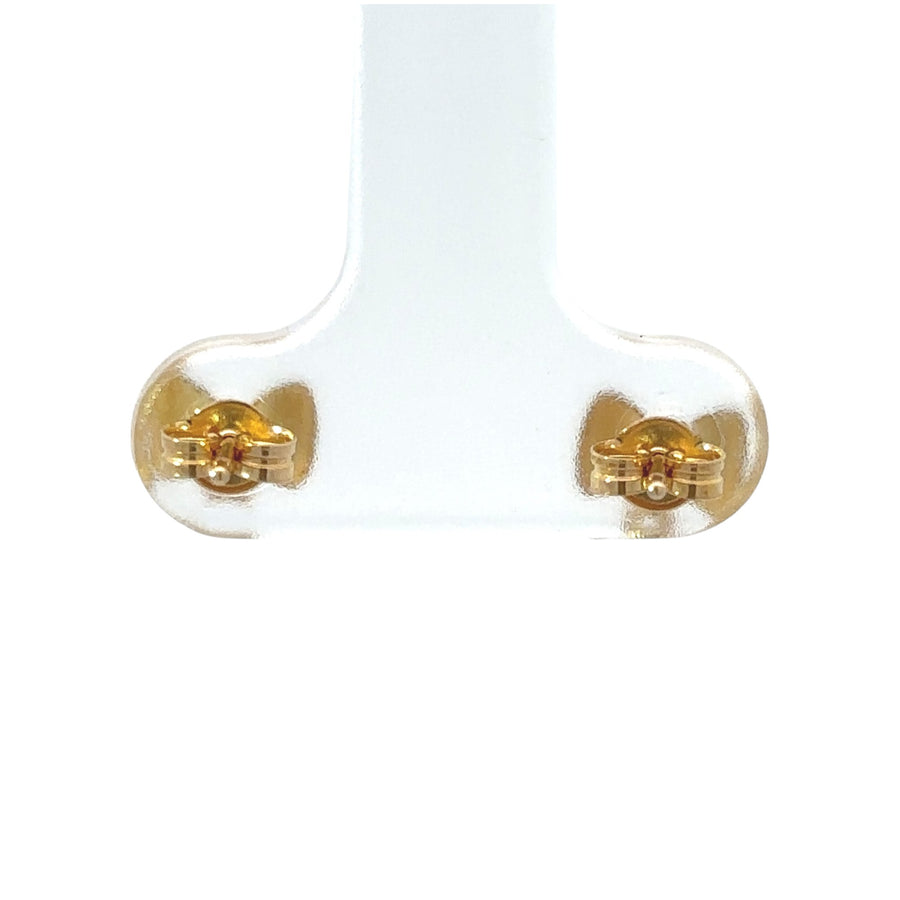 Delicate 18k gold earrings displayed in a jewelry box