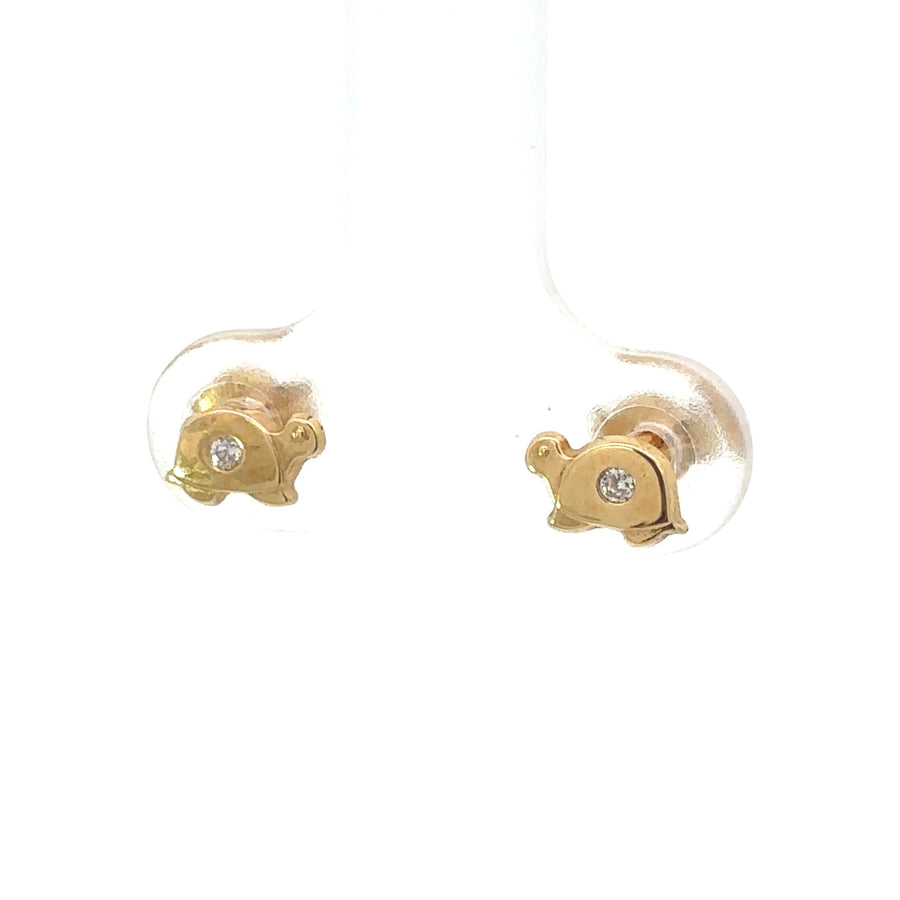 Close-up of 18k gold baby earrings on white background