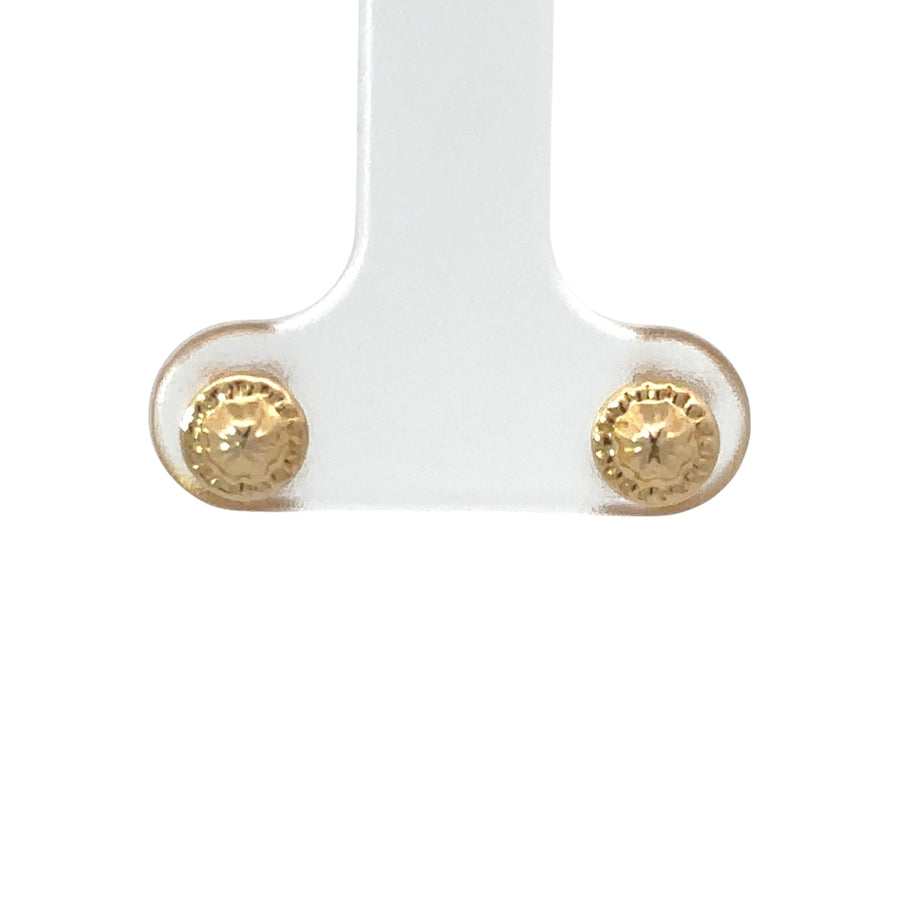 Baby wearing simple and elegant 18k gold earrings
