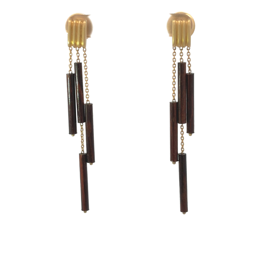 Close-up of 18k gold bamboo-style earrings with diamonds