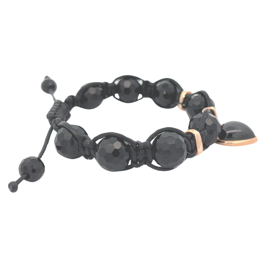 Close-up of Aga black stone on 18k gold bracelet