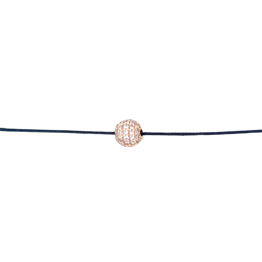 Woman wearing the adjustable 18k gold bracelet, showcasing its elegant fit and subtle charm.