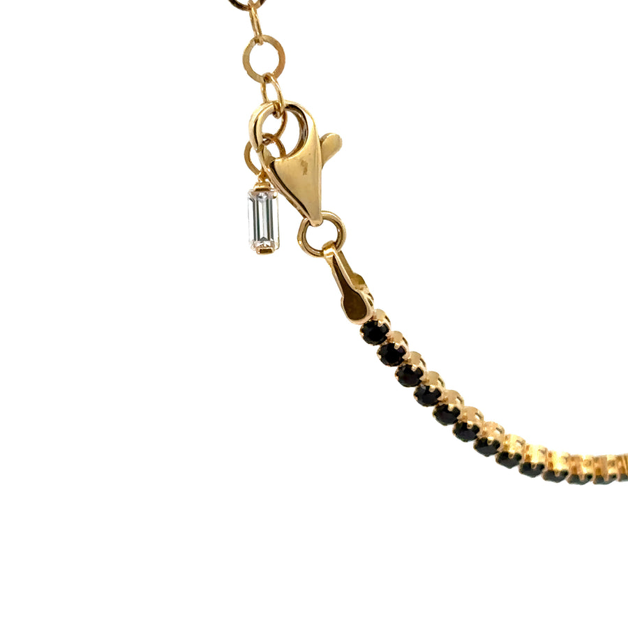 Woman wearing 18k gold bracelet with black onyx