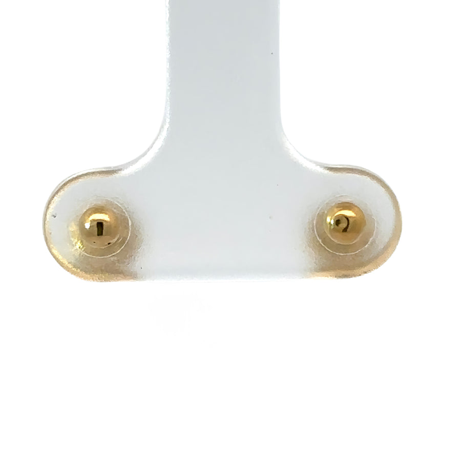 Close-up of classic 18k gold baby stud earrings