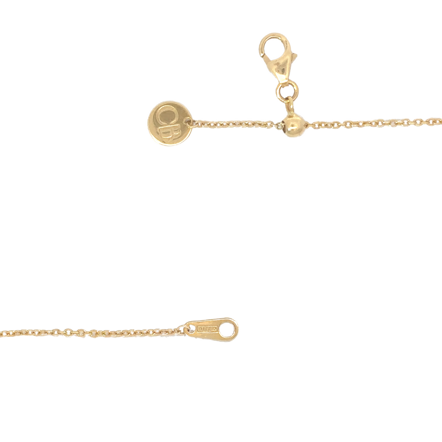 Model wearing the 18k gold double flower necklace with casual attire