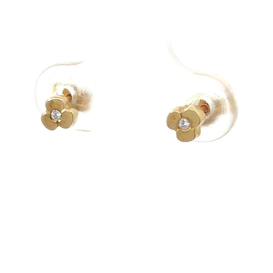Pair of baby-safe gold earrings on white background