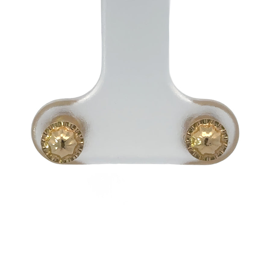 Side view of 18k gold flower studs showcasing detailed petals