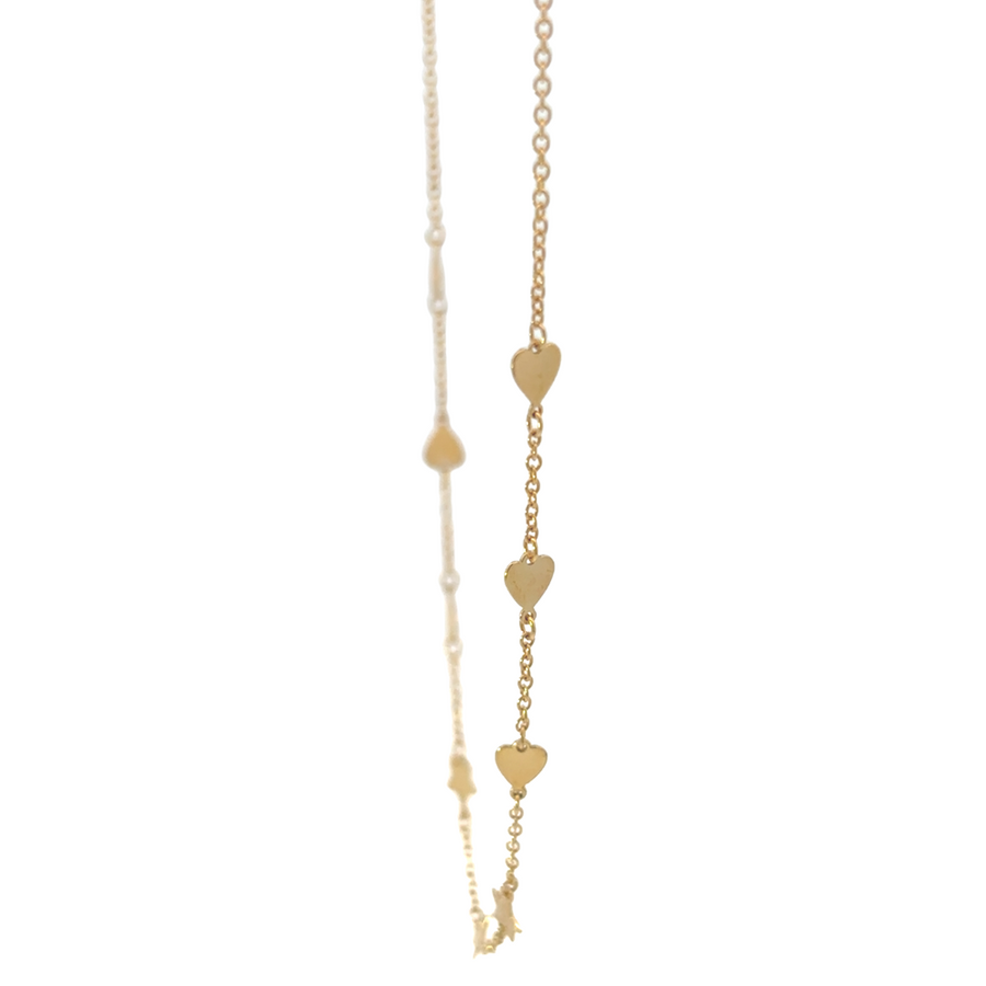 Close-up of heart and star pendants on gold chain