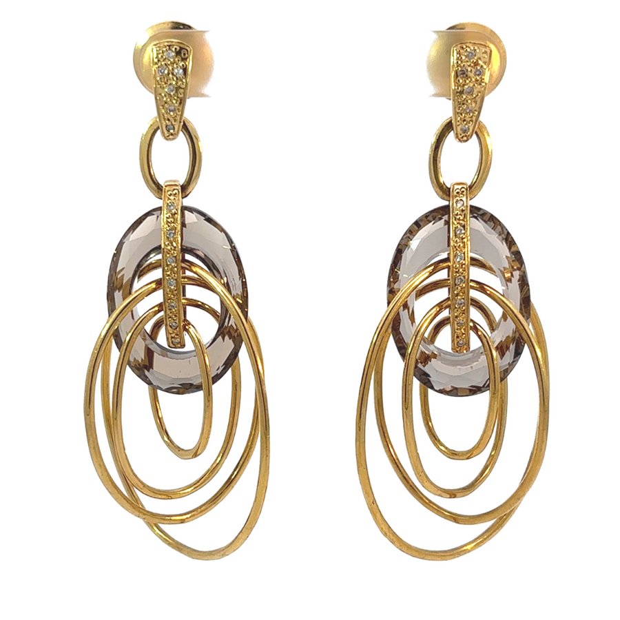 Close-up of 18k gold hoop earrings with smoky quartz stones