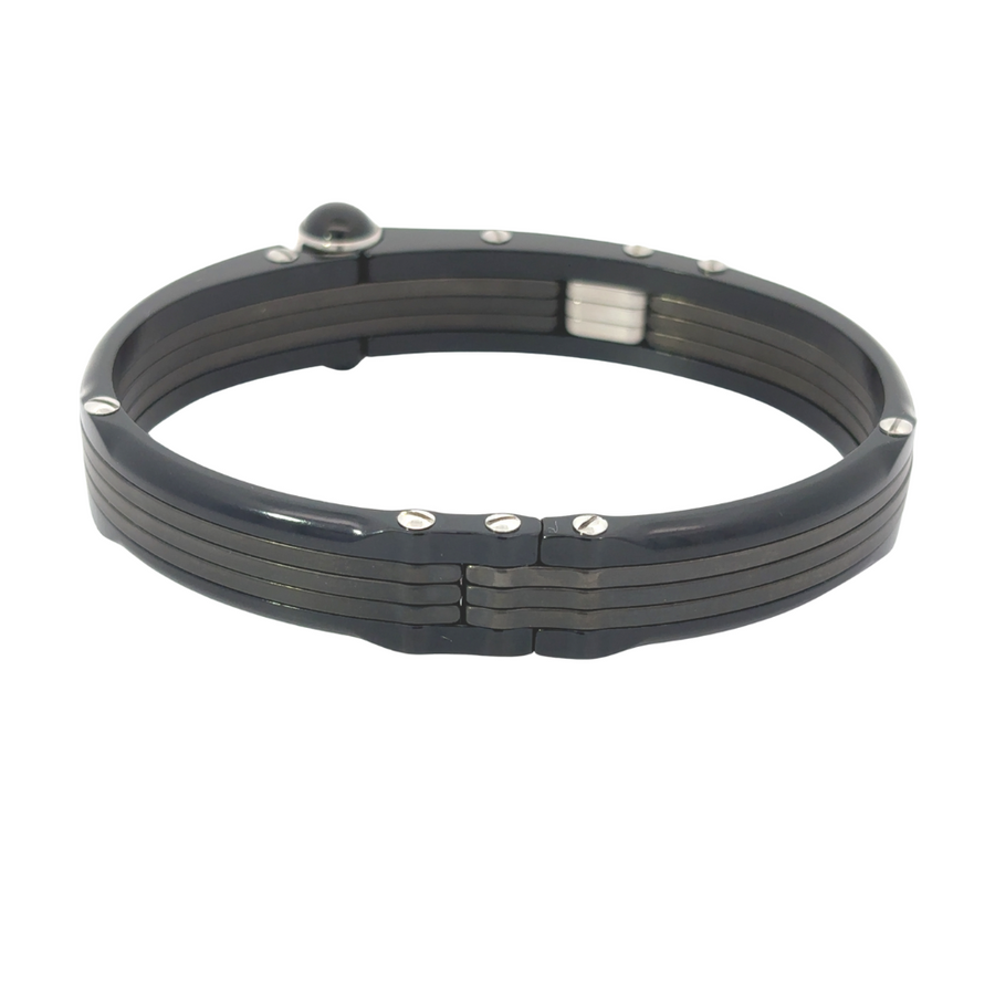 Wrist shot with gold and carbon bracelet styled with suit