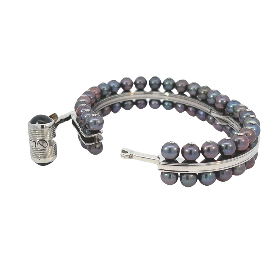 Man wearing 18k gold bracelet with pearl and diamond accents