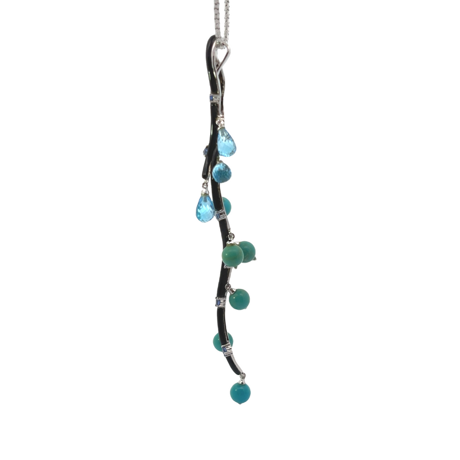 Close-up of multicolored gemstone pendant on gold chain