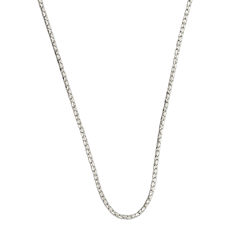 Woman wearing 18k gold necklace with vibrant stones