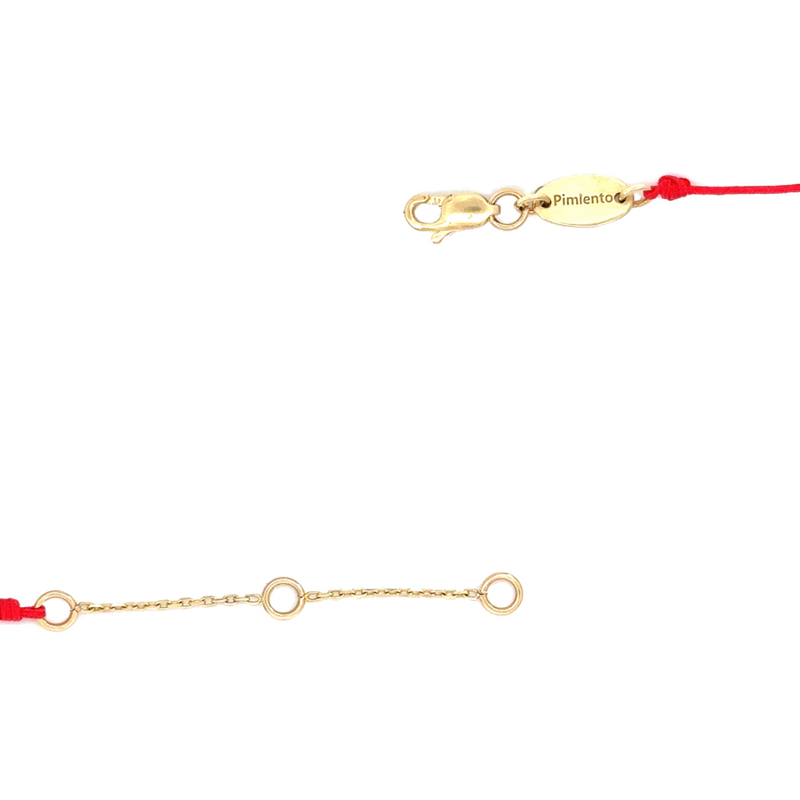 Macro shot of the red detail and bracelet clasp, emphasizing quality craftsmanship and adjustability.