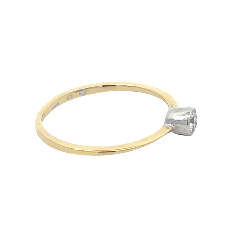 Close-up of 18k gold ring and sparkling gemstone