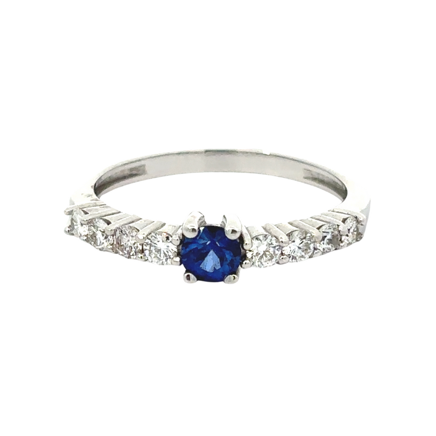 Close-up of sapphire surrounded by diamonds in gold ring